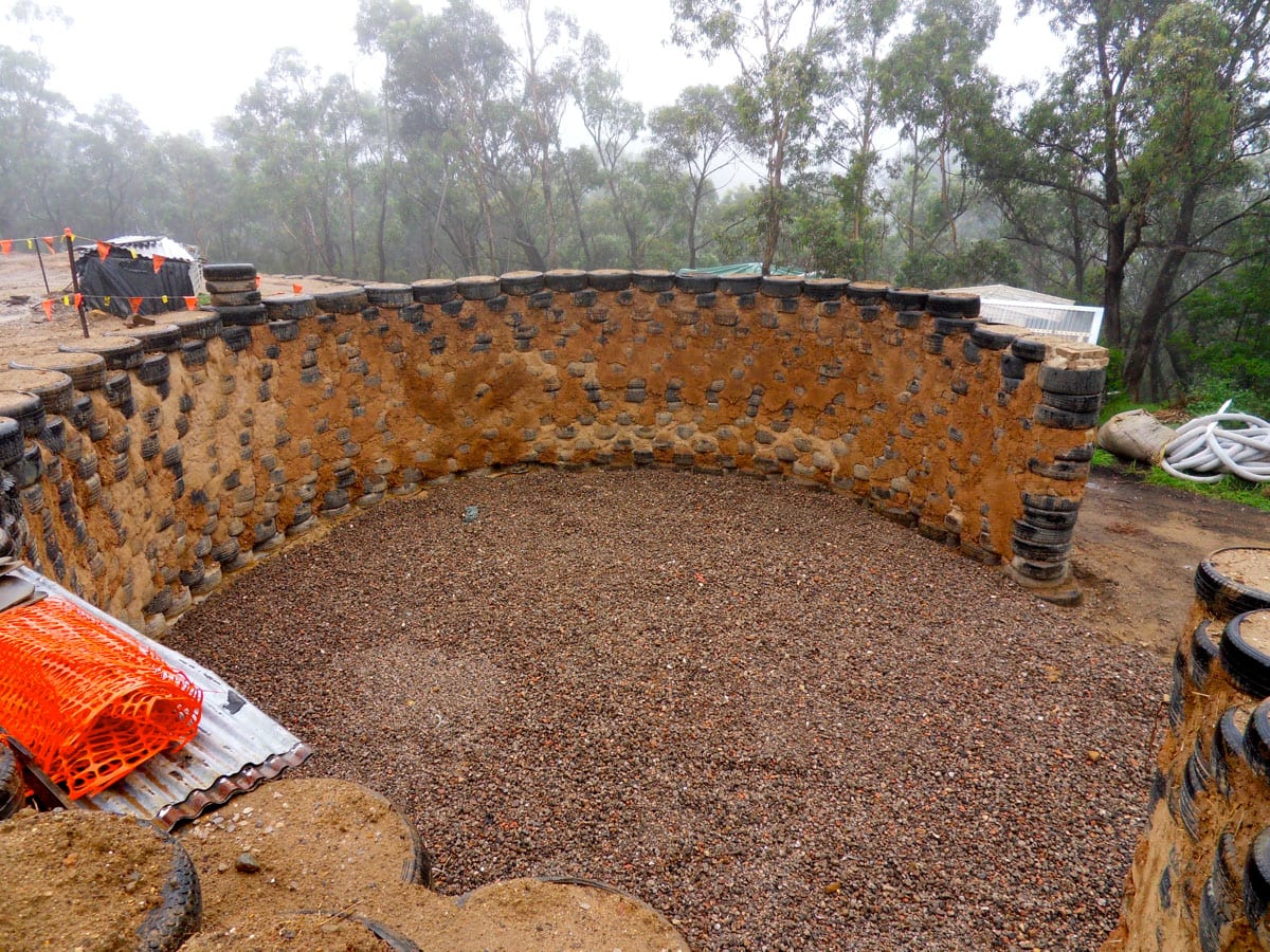 Recycled tyre wall built from sacred soil stands for environmental justice, protecting the natural flow of our land.